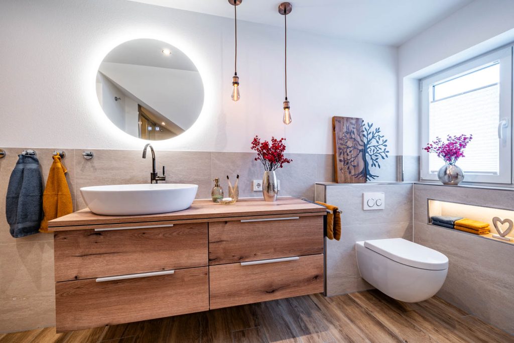 Waschtisch und Wand-WC mit beleuchteter Nische unter dem Fenster