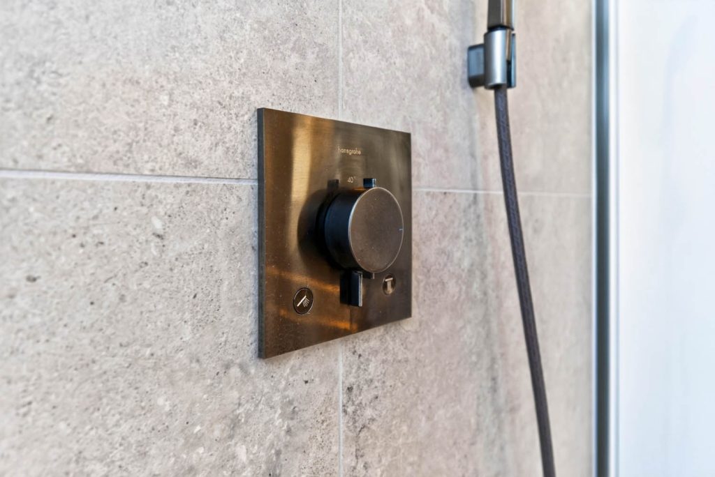 Unterputz-Thermostat in Bronze an der Duschwand